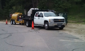 Truck towing equipment, surrounded by traffic cones.